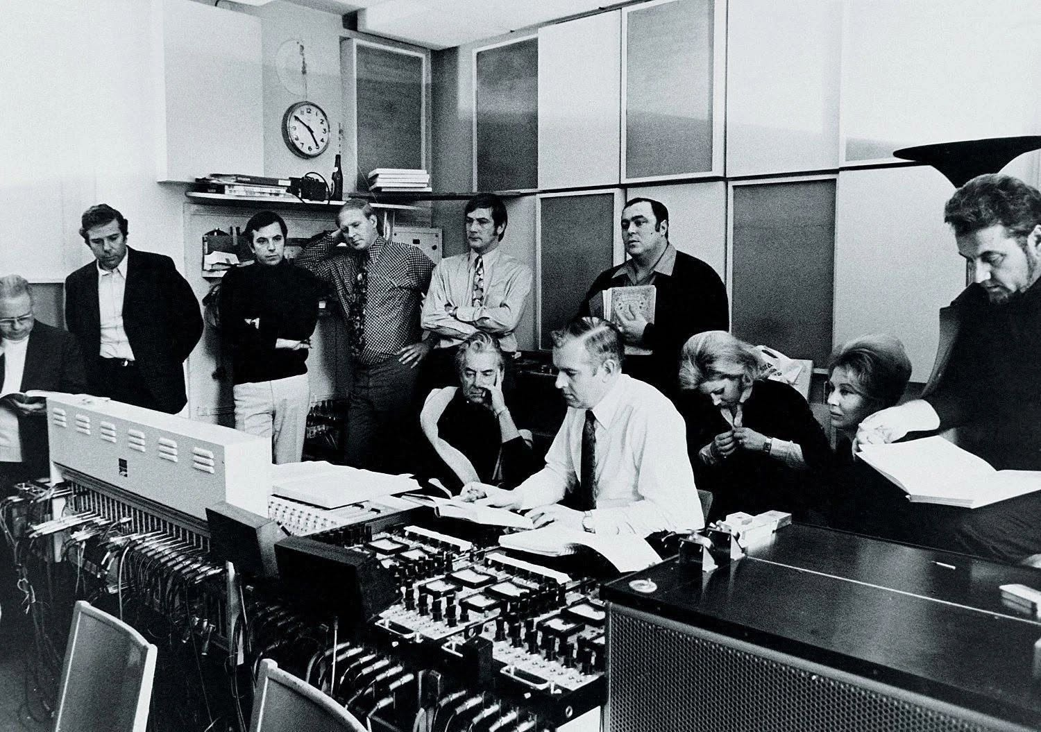 Producer Ray Minshull (seated centre) with Herbert von Karajan, Luciano Pavarotti, Mirella Freni, Elizabeth Harwood and Nicolai Ghiaurov at sessions for Puccini's "La Bohème". Recorded at Jesus-Christus-Kirche, Berlin, October 1972, for Decca Records.